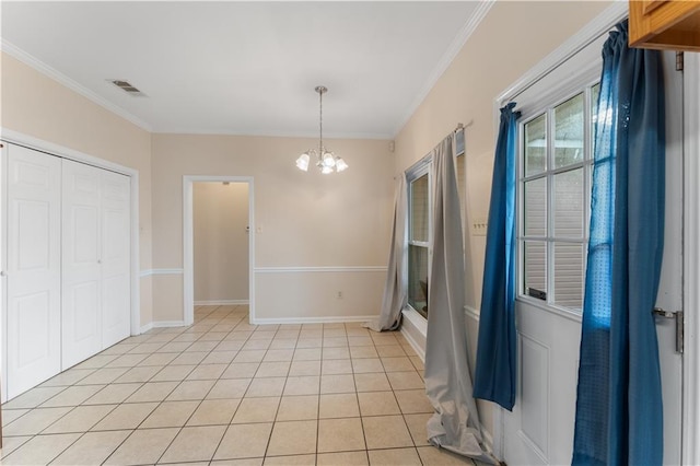 interior space with light tile patterned floors, crown molding, and a chandelier