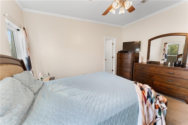 bedroom with ceiling fan, carpet, and ornamental molding