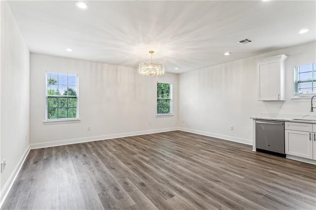 interior space featuring a wealth of natural light, visible vents, dark wood finished floors, and a sink