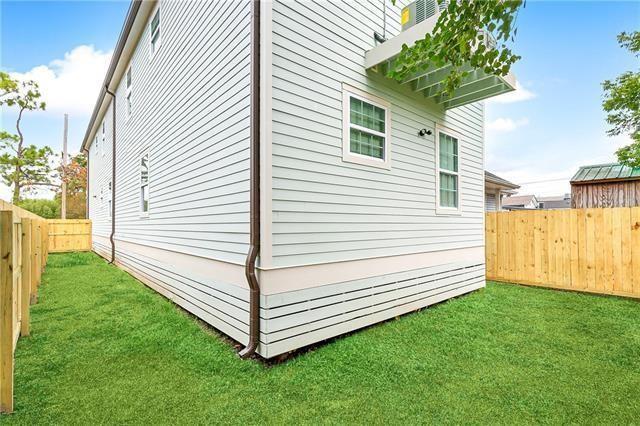 view of property exterior featuring a fenced backyard and a lawn