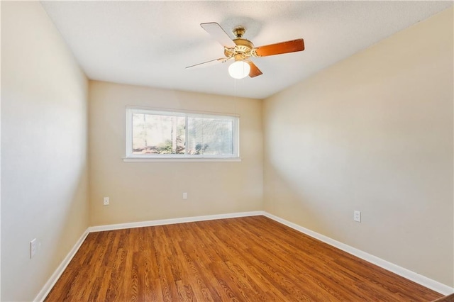 unfurnished room featuring ceiling fan and hardwood / wood-style floors