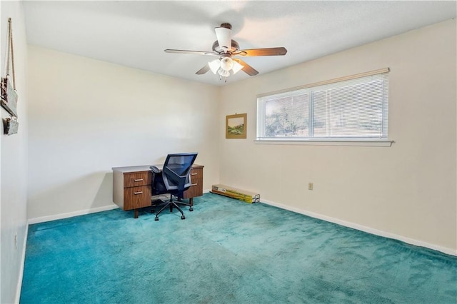 carpeted home office featuring ceiling fan