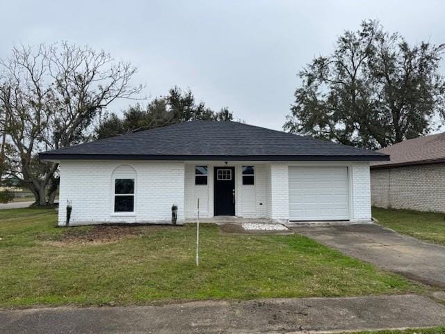 single story home with a garage and a front lawn