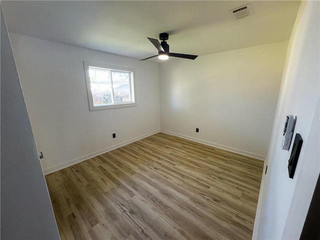 unfurnished room with ceiling fan and light wood-type flooring