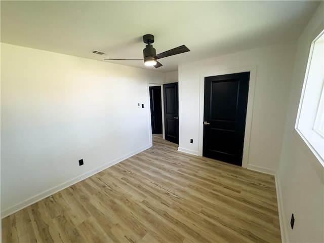 unfurnished bedroom with ceiling fan and light hardwood / wood-style flooring