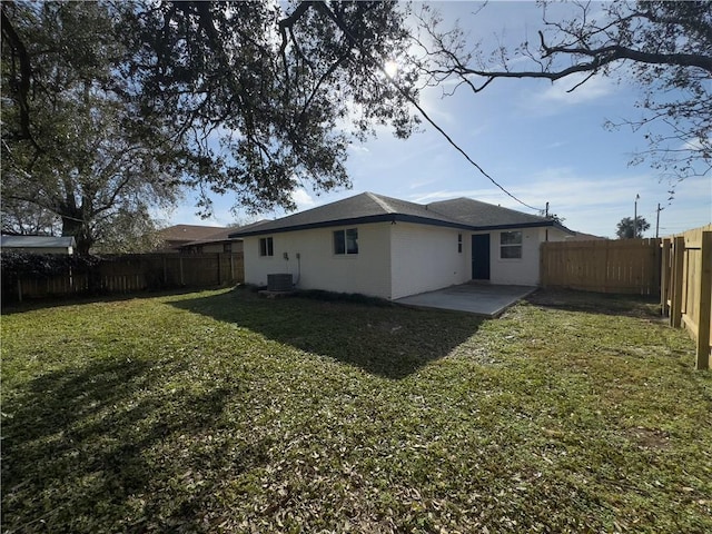 back of house with a patio area and a lawn