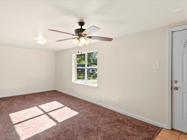 carpeted empty room featuring ceiling fan