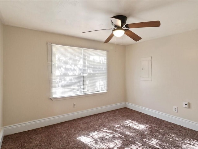 carpeted spare room featuring ceiling fan