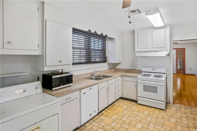 kitchen featuring ceiling fan, washer / dryer, sink, white appliances, and white cabinets