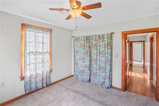 unfurnished bedroom with ceiling fan and light colored carpet