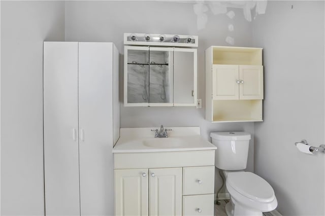 bathroom featuring toilet and vanity