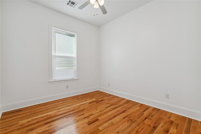 spare room with ceiling fan and wood-type flooring