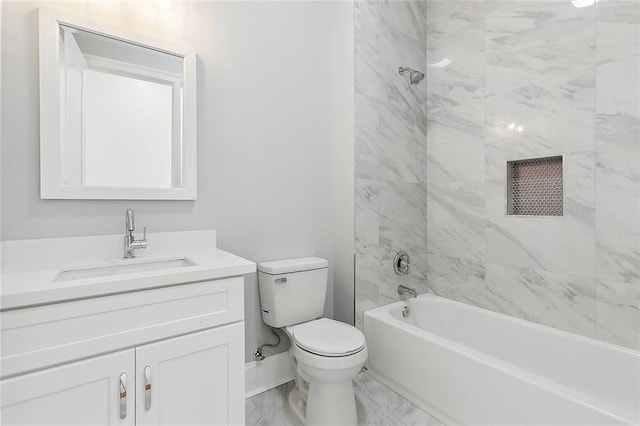 full bathroom featuring vanity, tiled shower / bath combo, and toilet