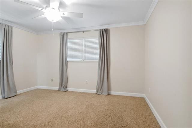 spare room with crown molding, ceiling fan, and light carpet