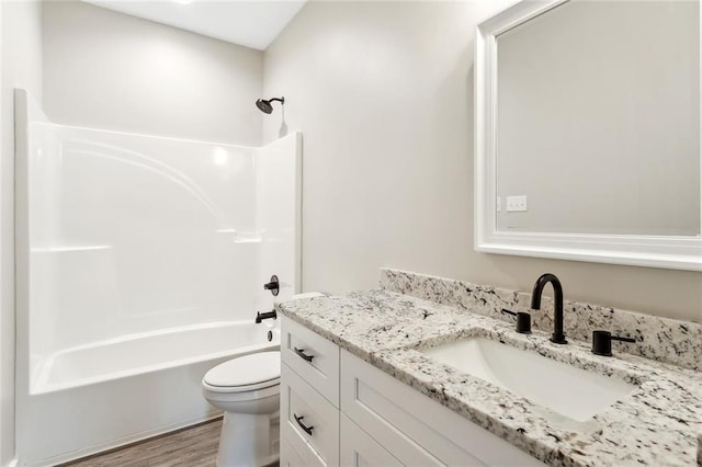 full bathroom with toilet, vanity, shower / bath combination, and hardwood / wood-style floors