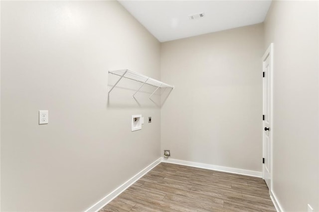 laundry area featuring wood-type flooring, hookup for a washing machine, and electric dryer hookup