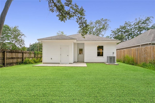 back of house featuring a patio area, a yard, and central AC