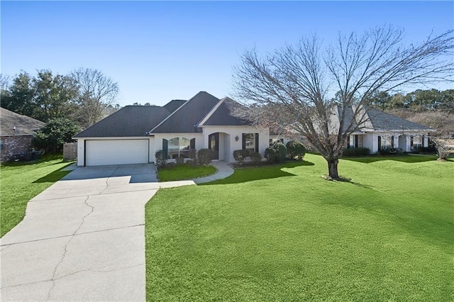 view of front of house with a front yard and a garage