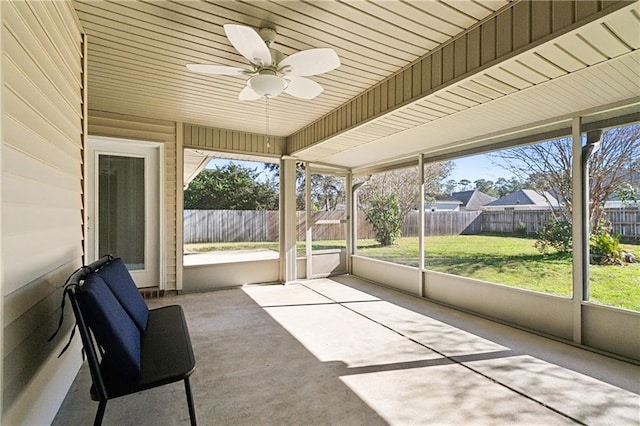 unfurnished sunroom featuring ceiling fan