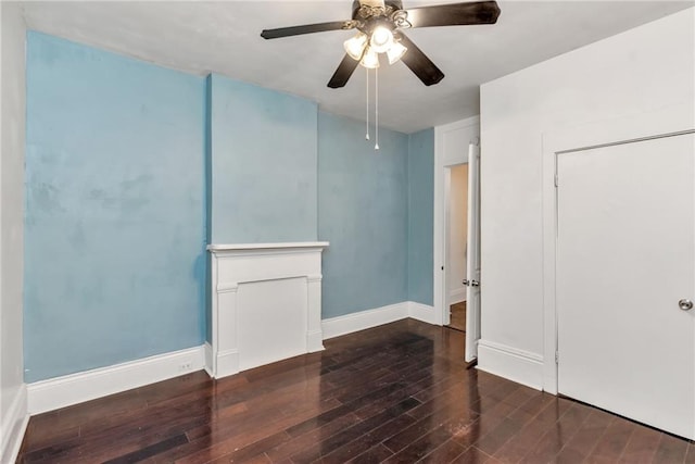 spare room with ceiling fan and dark wood-type flooring