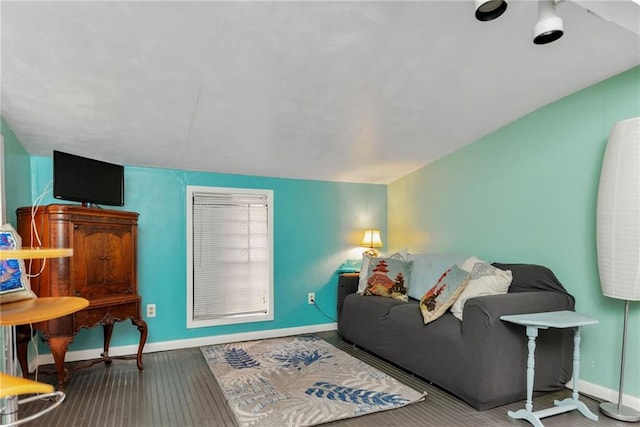 living room featuring lofted ceiling