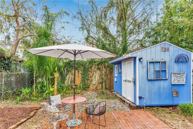 view of patio / terrace with a shed