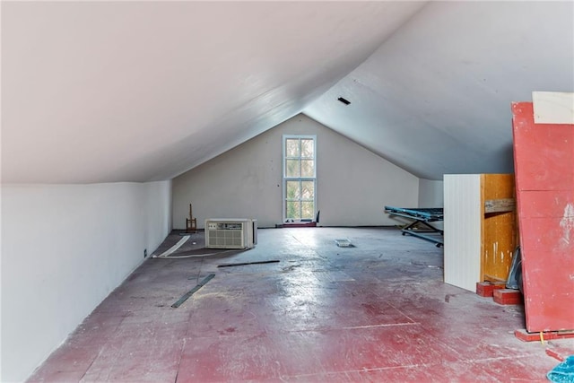 bonus room featuring a wall mounted AC and vaulted ceiling