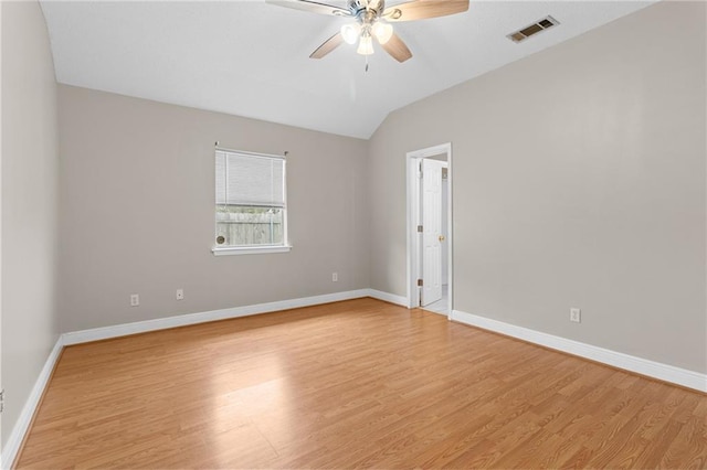 spare room with ceiling fan, light wood-type flooring, and lofted ceiling