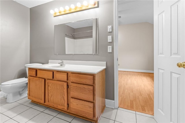 bathroom featuring toilet, vanity, and tile patterned flooring