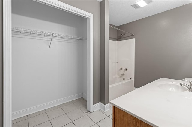 bathroom featuring shower / bathtub combination, tile patterned flooring, and vanity