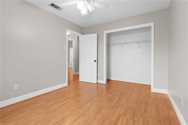 unfurnished bedroom featuring ceiling fan, a closet, and light hardwood / wood-style floors