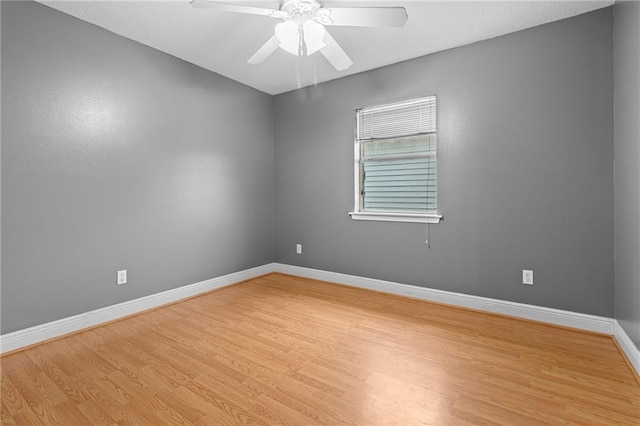 spare room with ceiling fan and light hardwood / wood-style flooring