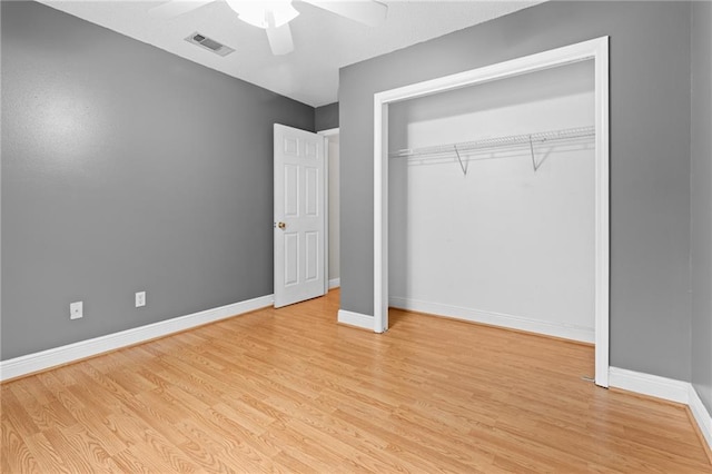 unfurnished bedroom featuring ceiling fan, a closet, and light hardwood / wood-style floors