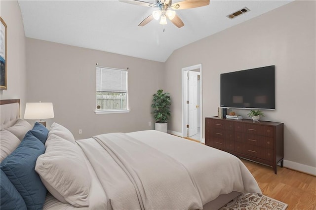 bedroom featuring ceiling fan, lofted ceiling, and light hardwood / wood-style flooring