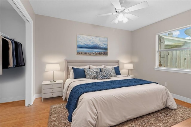 bedroom featuring ceiling fan, a closet, and light hardwood / wood-style flooring