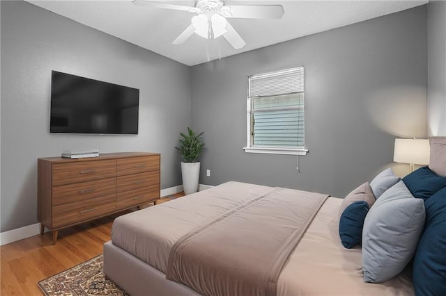 bedroom with ceiling fan and hardwood / wood-style flooring