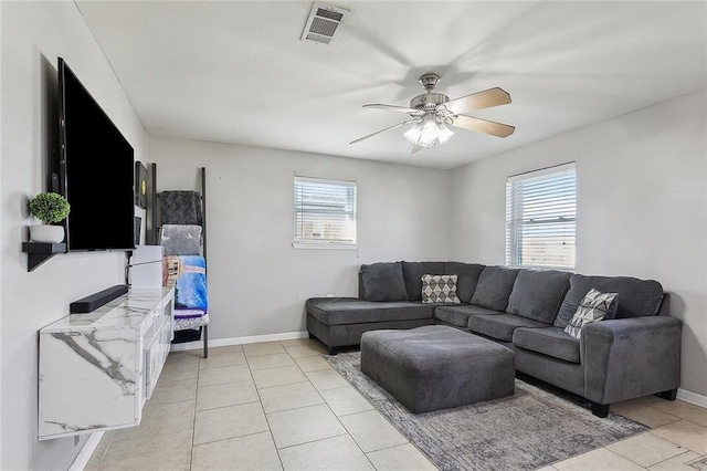 living room with ceiling fan, plenty of natural light, and light tile patterned flooring