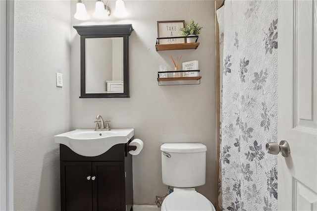 bathroom with toilet and vanity