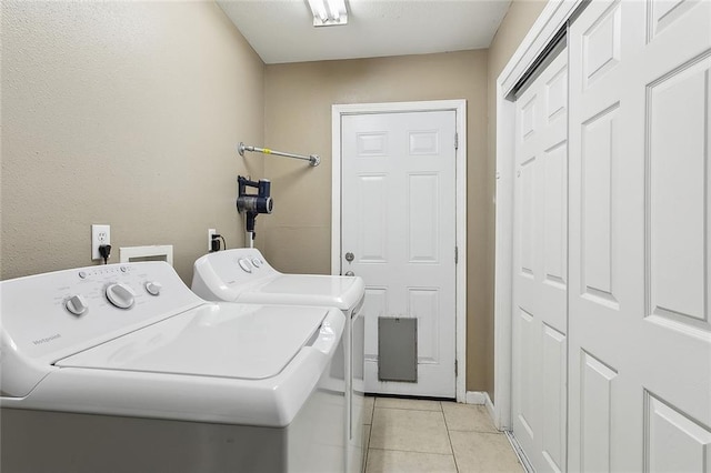 laundry room with light tile patterned floors and independent washer and dryer