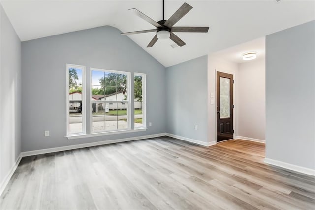 unfurnished room featuring ceiling fan, lofted ceiling, and light hardwood / wood-style floors