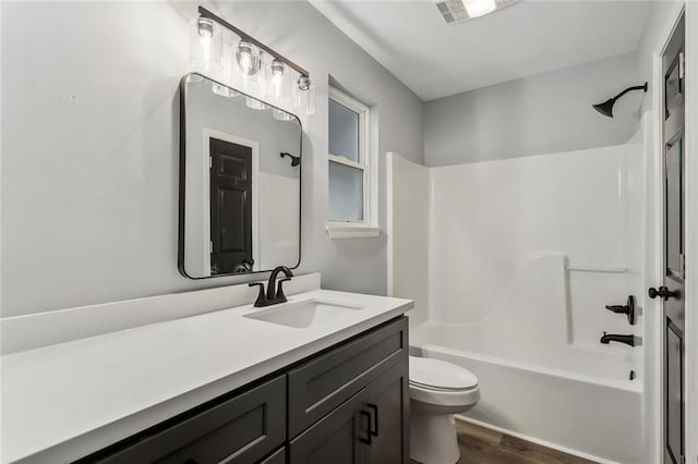 full bathroom with vanity, toilet, tub / shower combination, and hardwood / wood-style floors