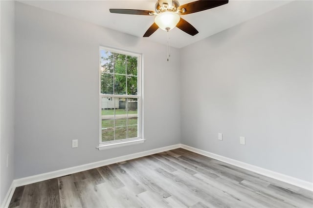 empty room with ceiling fan, light hardwood / wood-style flooring, and a healthy amount of sunlight