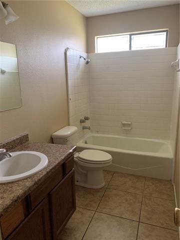 full bathroom with tile patterned flooring, tiled shower / bath combo, toilet, and a healthy amount of sunlight