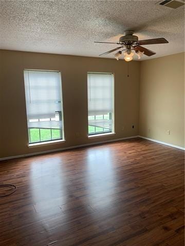 unfurnished room with ceiling fan and dark hardwood / wood-style floors