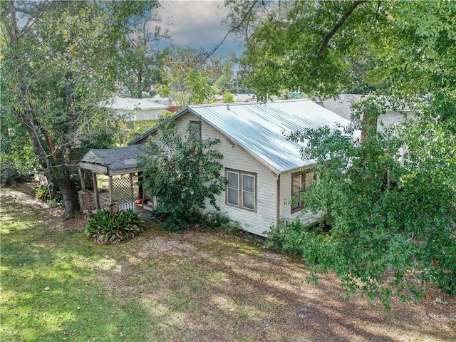 view of side of home with a lawn