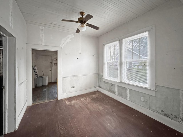 empty room with ceiling fan and dark hardwood / wood-style flooring