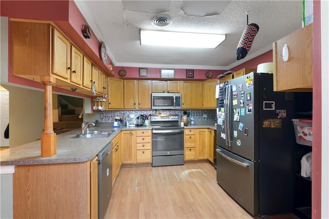 kitchen featuring backsplash, sink, light wood-type flooring, appliances with stainless steel finishes, and ornamental molding