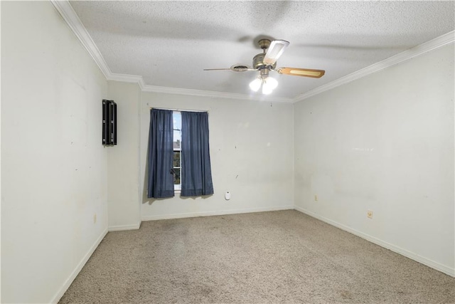 spare room with ceiling fan, a textured ceiling, ornamental molding, and carpet flooring