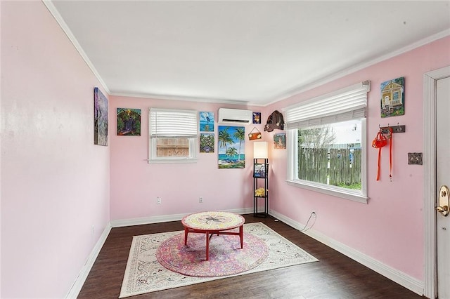 living area with an AC wall unit, dark wood-type flooring, and ornamental molding