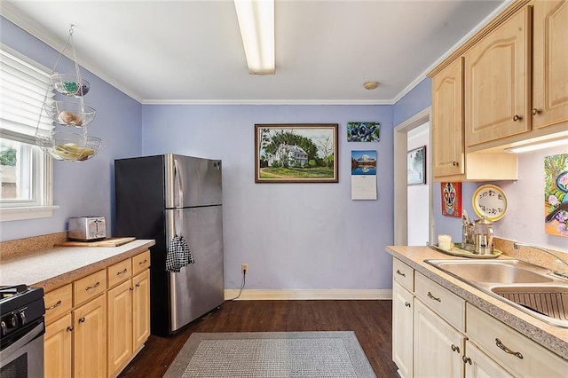 kitchen with stainless steel fridge, light brown cabinets, stove, crown molding, and sink